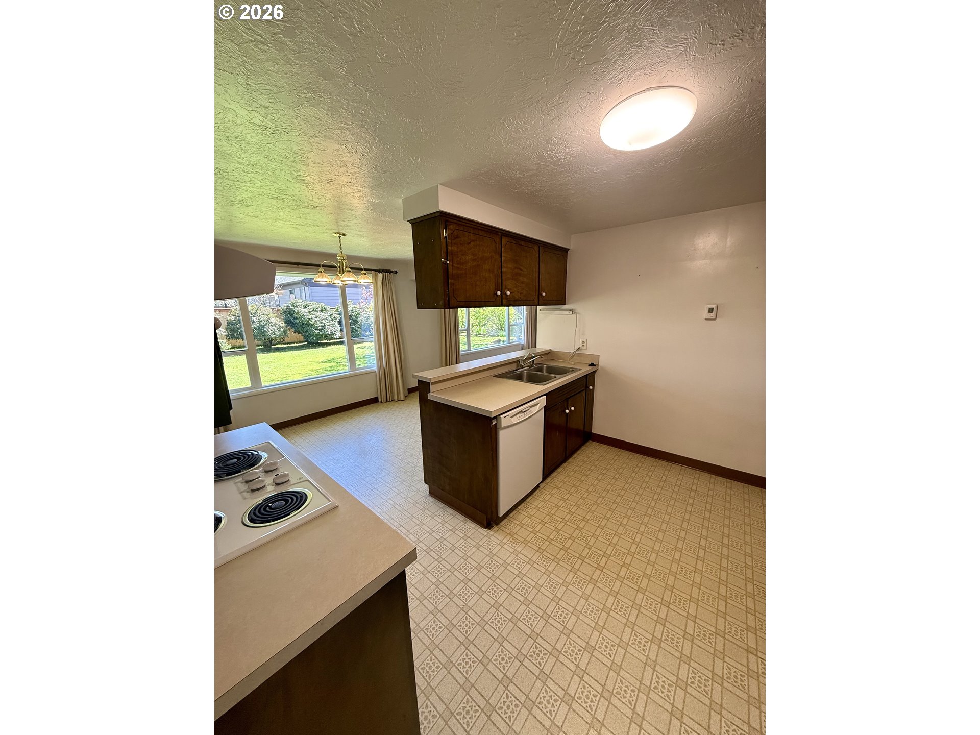 349 Van Duyn Street Eugene, OR 97401 - Photo 9 of 24 a kitchen with stainless steel appliances granite countertop a sink and a stove top oven