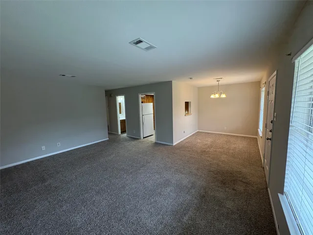 a view of an empty room with a fireplace