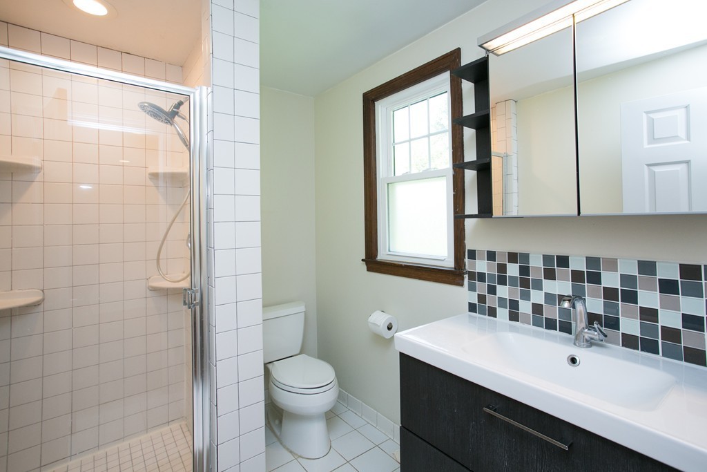37 Valley Road Needham, MA 02492 - Photo 11 of 19 a bathroom with a sink a toilet and shower