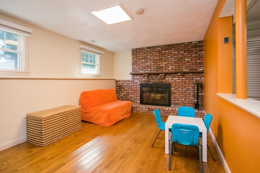 37 Valley Road Needham, MA 02492 - Photo 15 of 19 a bedroom with furniture and a fireplace