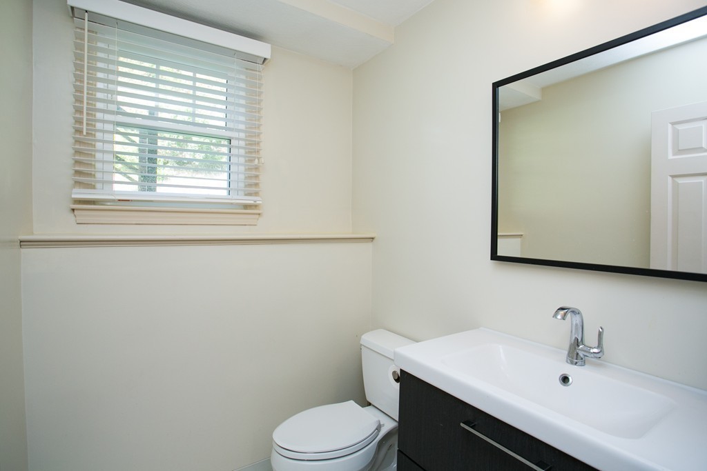 37 Valley Road Needham, MA 02492 - Photo 16 of 19 a bathroom with a sink a toilet and mirror