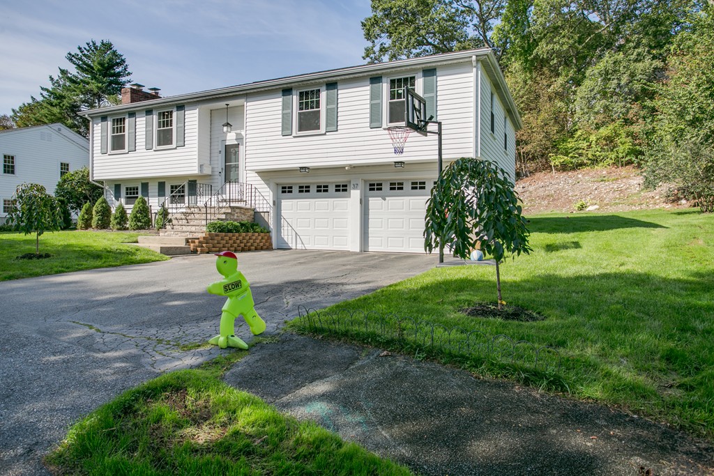 37 Valley Road Needham, MA 02492 - Photo 2 of 19 a front view of a house with a garden and yard