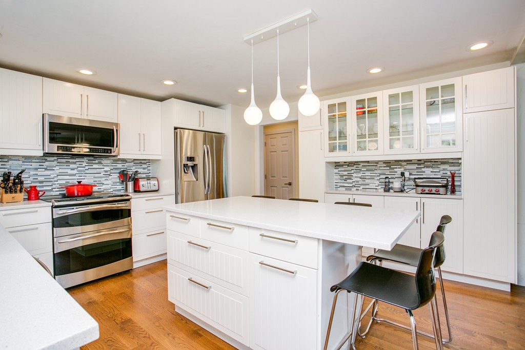 37 Valley Road Needham, MA 02492 - Photo 7 of 19 a kitchen with kitchen island a stove and a refrigerator