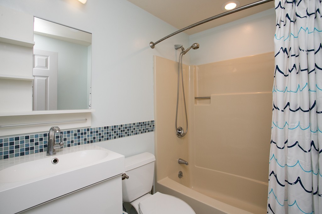 37 Valley Road Needham, MA 02492 - Photo 10 of 19 a bathroom with a bathtub and shower