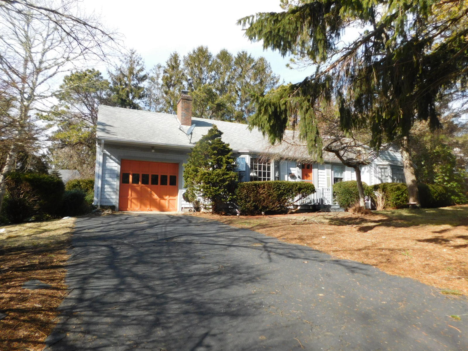 79 Joan Road Centerville, MA 02632 - Photo 1 of 4 a front view of a house with a yard and tree s