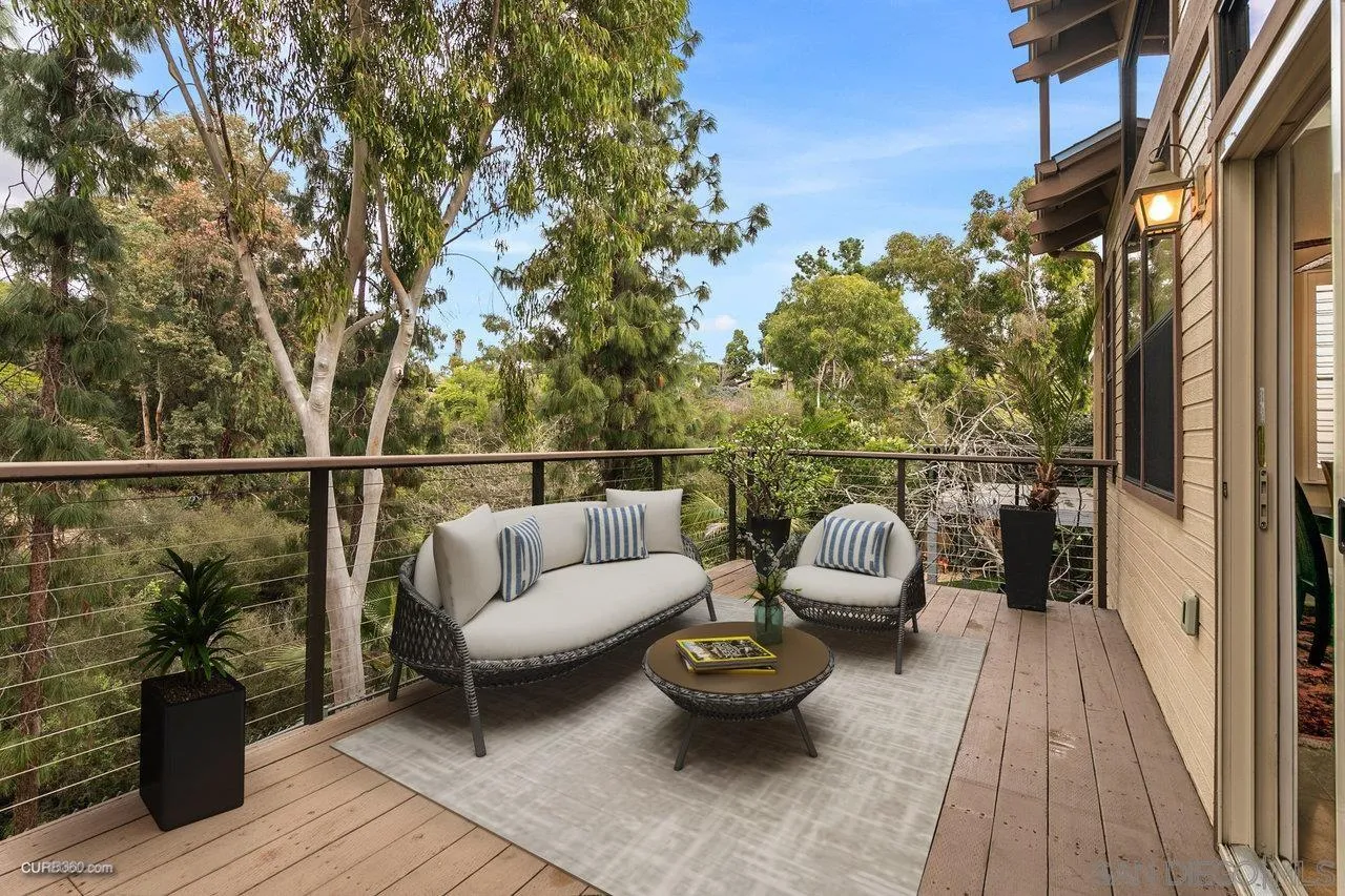 a balcony with wooden floor and outdoor seating