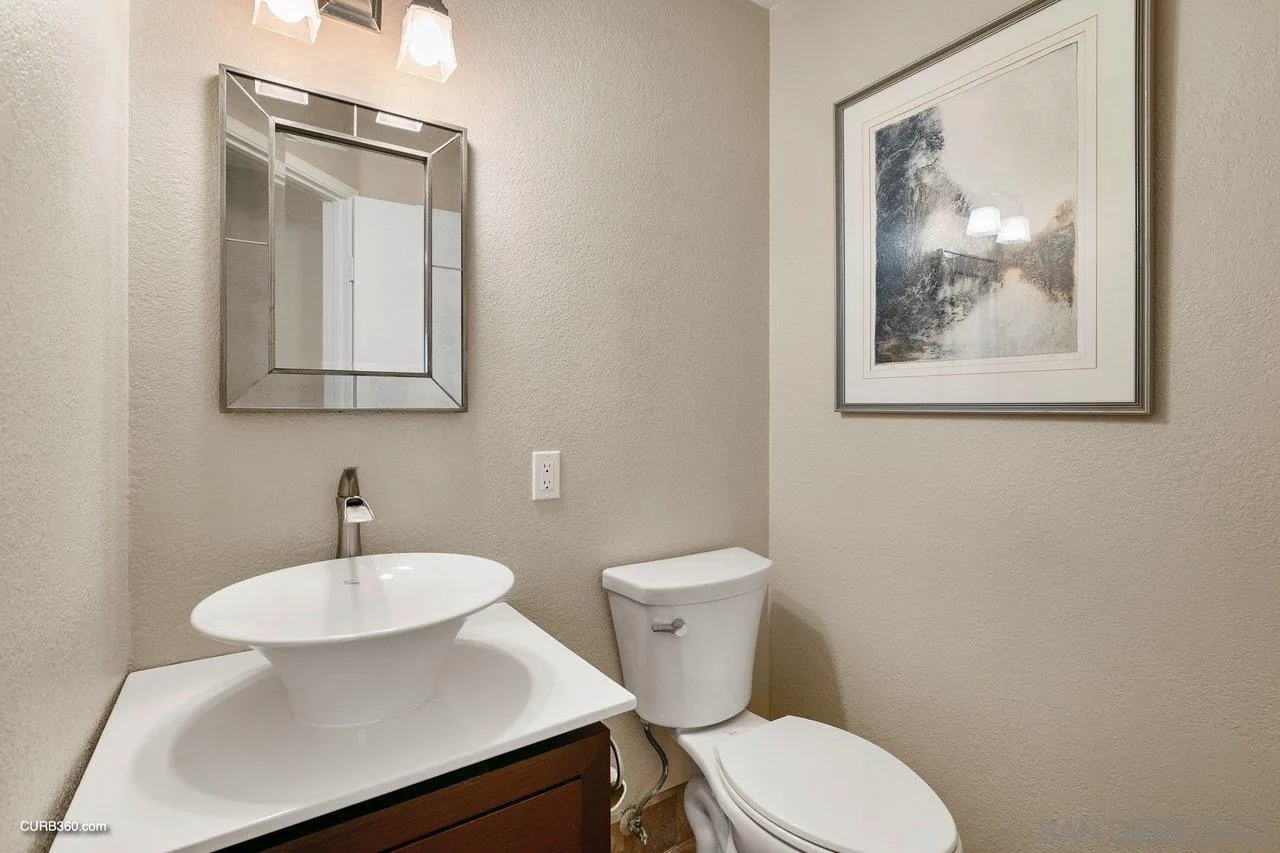 4579 54th Street San Diego, CA 92115 - Photo 14 of 39 a bathroom with a toilet a sink and mirror