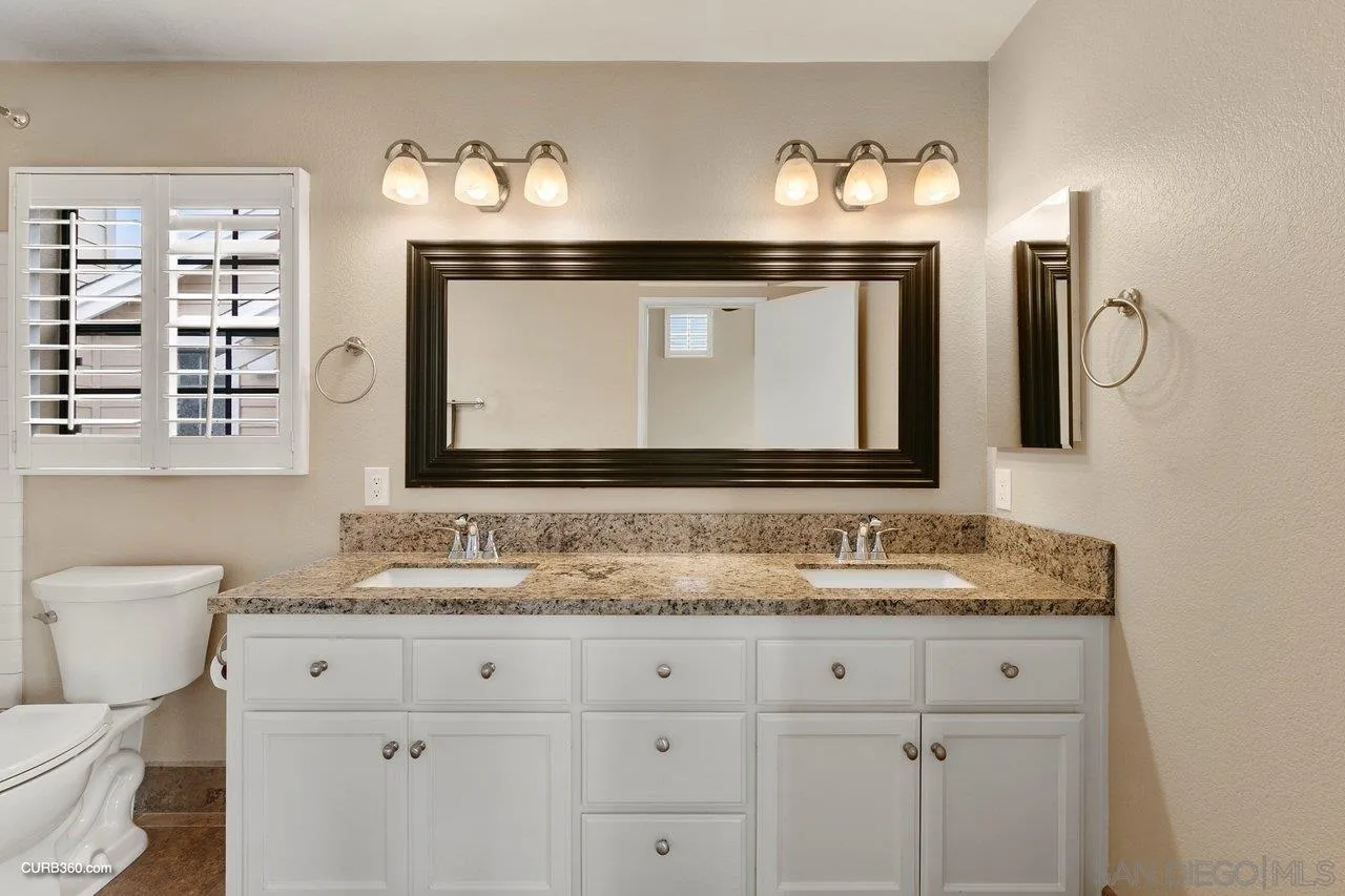4579 54th Street San Diego, CA 92115 - Photo 22 of 39 a bathroom with double vanity sink and a mirror
