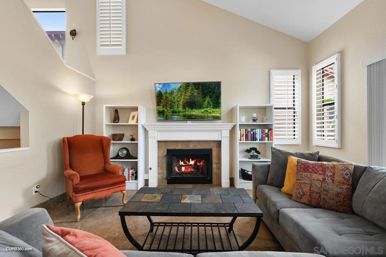 4579 54th Street San Diego, CA 92115 - Photo 3 of 39 a living room with furniture a flat screen tv and a fireplace
