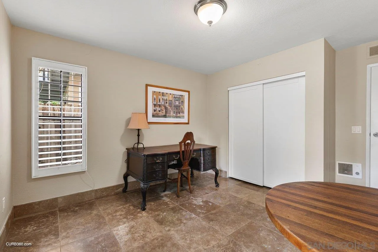 4579 54th Street San Diego, CA 92115 - Photo 32 of 39 a view of a workspace with furniture and a window