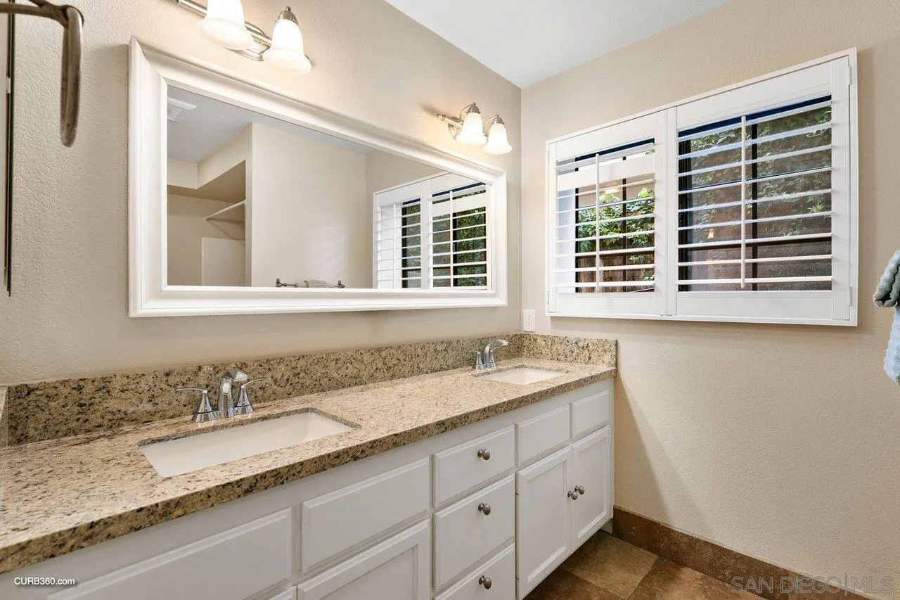 4579 54th Street San Diego, CA 92115 - Photo 33 of 39 a bathroom with a granite countertop sink and a window