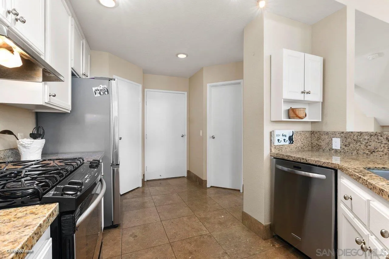 4579 54th Street San Diego, CA 92115 - Photo 8 of 39 a kitchen with stainless steel appliances granite countertop a stove and a refrigerator