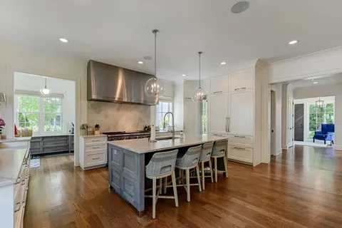 a large kitchen with kitchen island a sink a center island stainless steel appliances and a center island