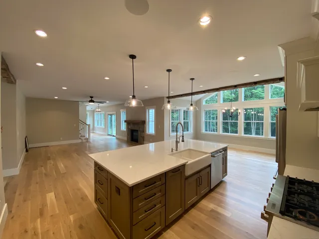 a kitchen with a sink and wooden floor