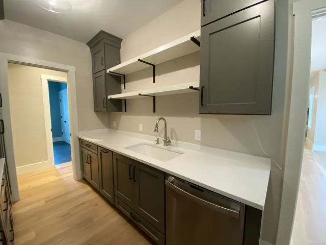 a kitchen with a sink and a mirror