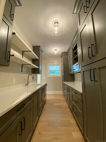 a large kitchen with stainless steel appliances kitchen island granite countertop a sink and cabinets