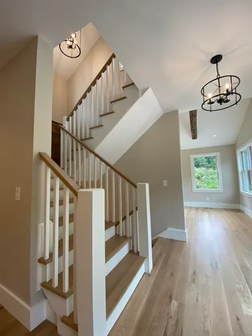 a view of entryway and hall with wooden floor