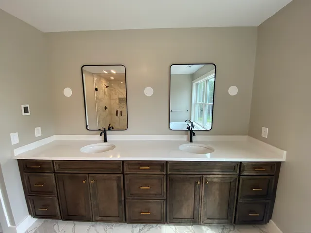 a bathroom with a granite countertop sink vanity and mirror