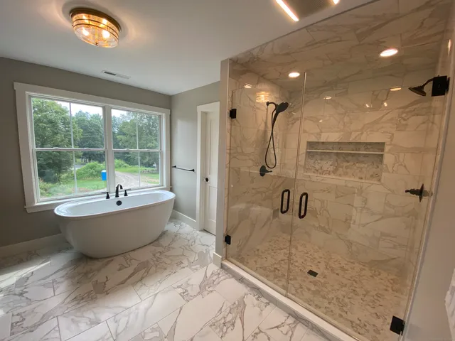 a bathroom with a bathtub and shower
