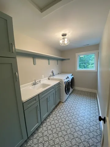 a room with a washing machine and sink