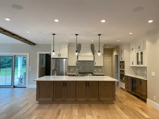 a large kitchen with stainless steel appliances kitchen island granite countertop a large counter top and stove in it