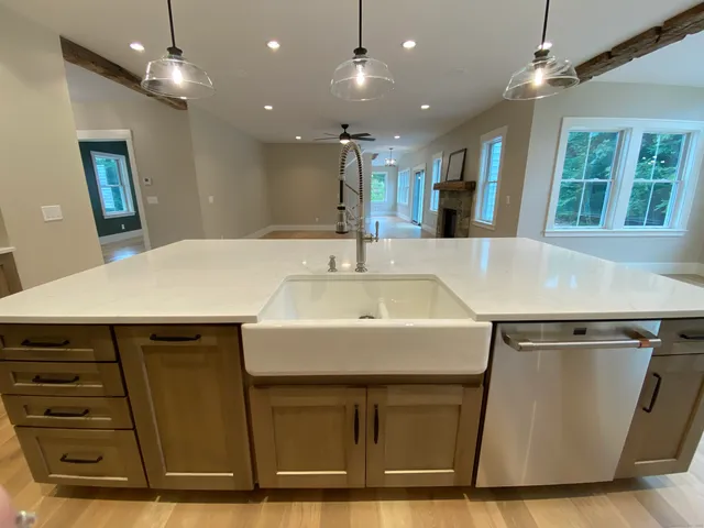 a kitchen with kitchen island a sink stainless steel appliances and window