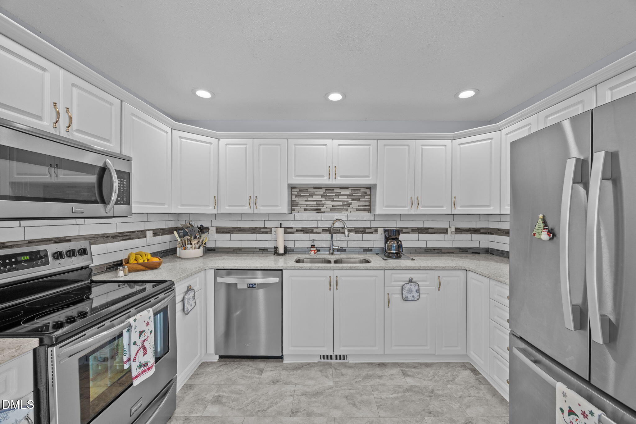 6194 Friedens Grove Road Gibsonville, NC 27249 - Photo 12 of 23 a kitchen with stainless steel appliances granite countertop a stove top oven a refrigerator a sink and dishwasher with white cabinets