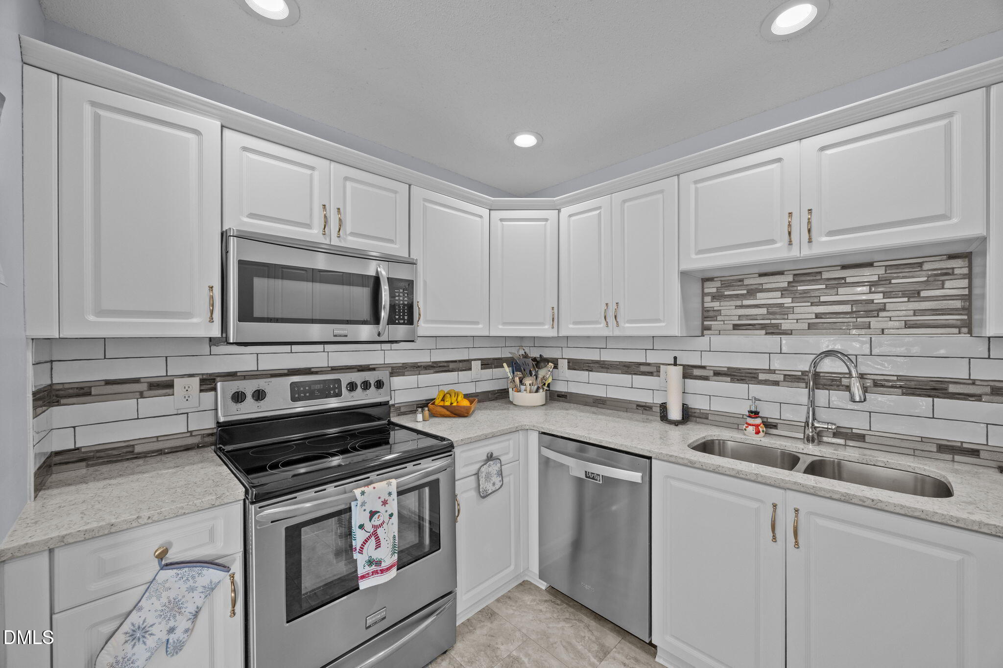 6194 Friedens Grove Road Gibsonville, NC 27249 - Photo 13 of 23 a kitchen with stainless steel appliances a stove a sink and a microwave