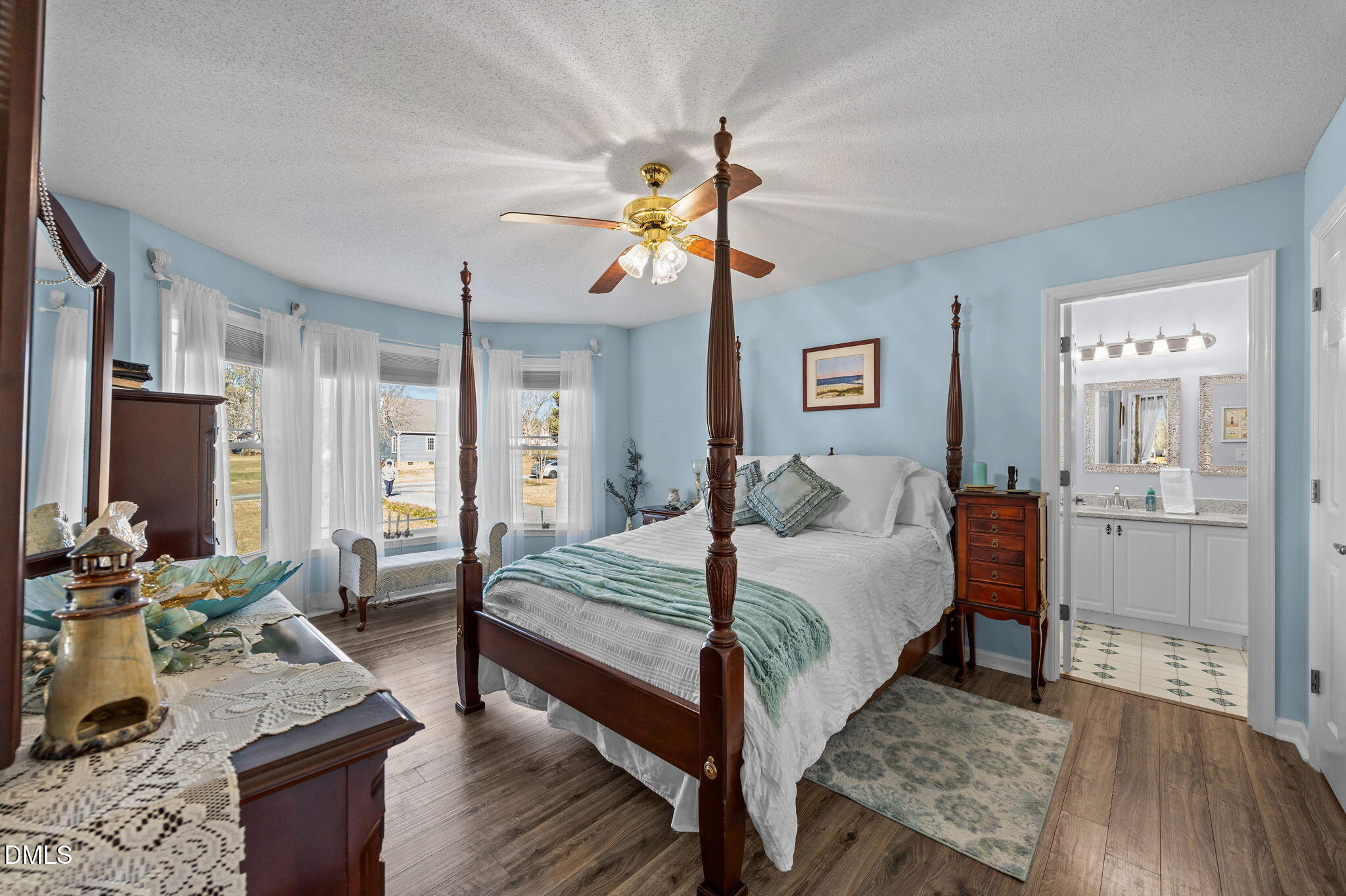 6194 Friedens Grove Road Gibsonville, NC 27249 - Photo 4 of 23 a bedroom with a bed and wooden floor