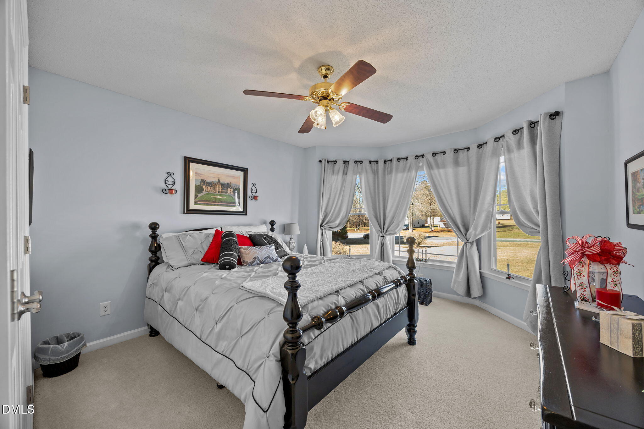 6194 Friedens Grove Road Gibsonville, NC 27249 - Photo 6 of 23 a bedroom with a bed and a chandelier