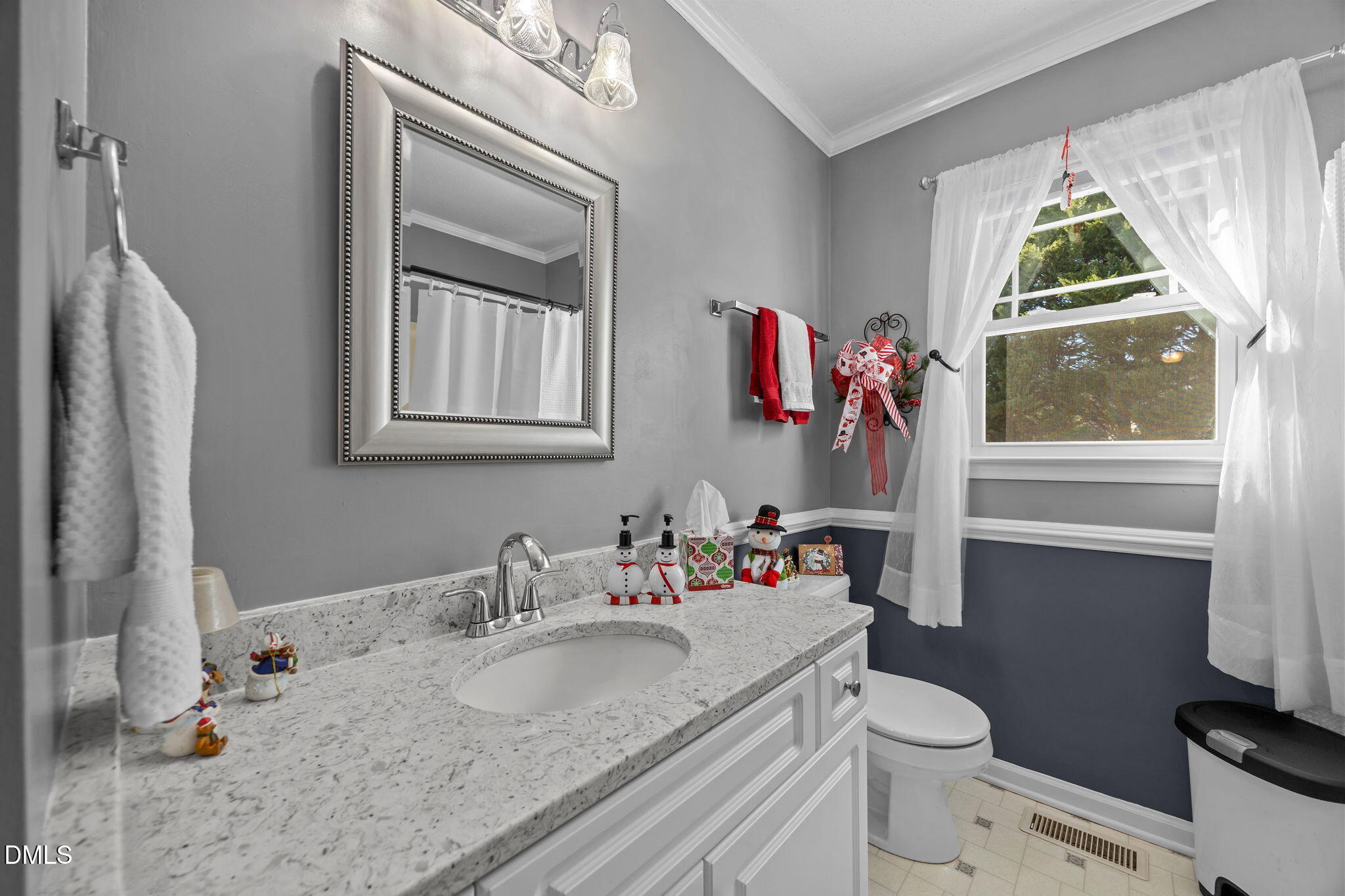 6194 Friedens Grove Road Gibsonville, NC 27249 - Photo 7 of 23 a bathroom with a granite countertop sink vanity mirror and toilet