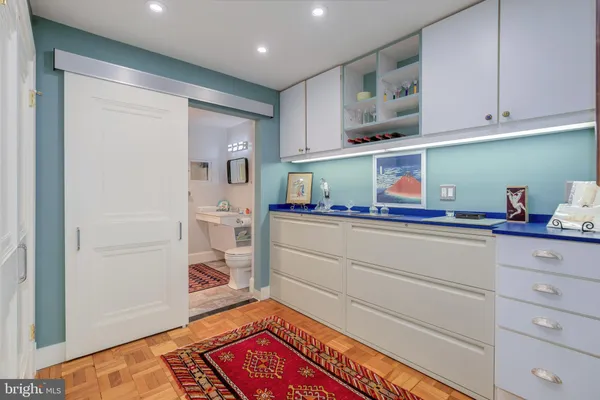 a kitchen with cabinets and wooden floor