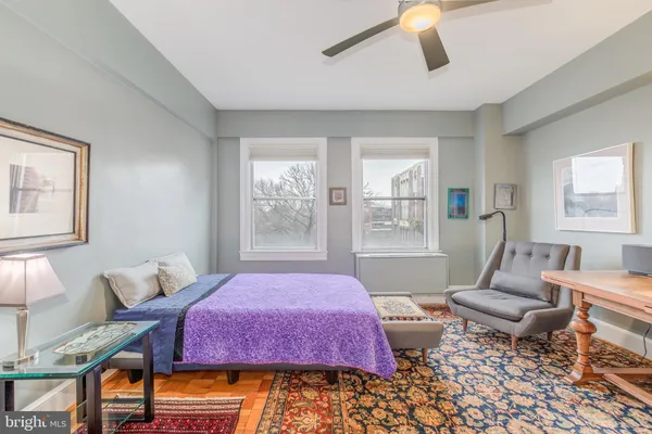 a bedroom with furniture and a window