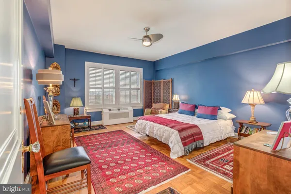a bedroom with two beds and a lamp