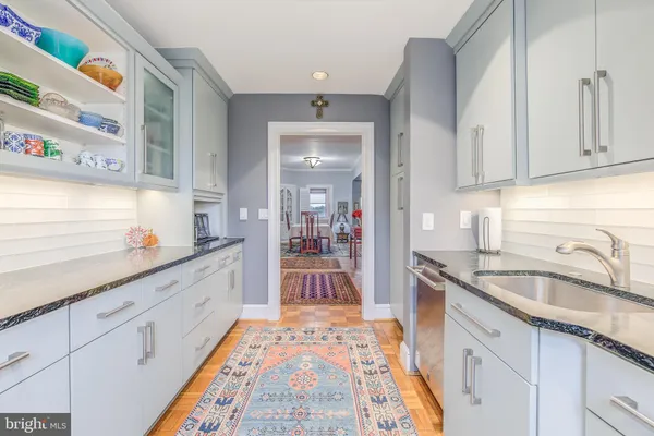 a kitchen with granite countertop lots of counter top space and sink