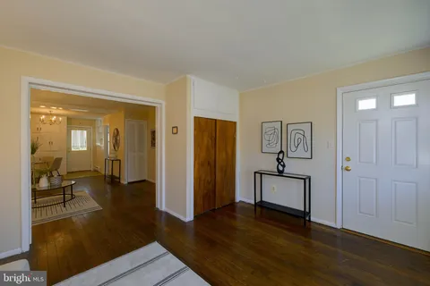 a view of a livingroom with wooden floor and furniture
