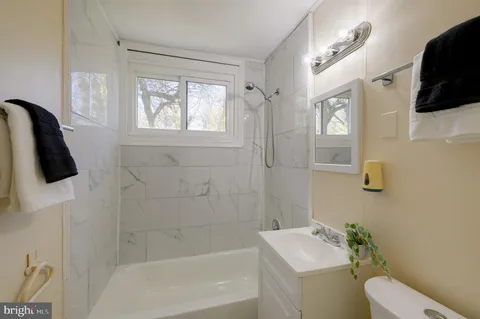 a bathroom with a toilet a sink and bath tub