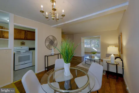 a living room with kitchen island furniture and a chandelier