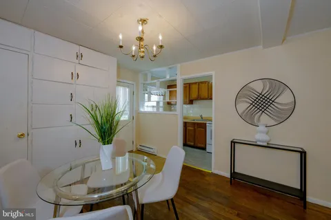 a view of a dining room with furniture wooden floor and chandelier