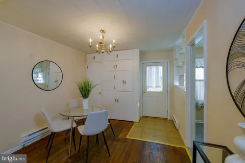 a view of a dining room with furniture and chandelier