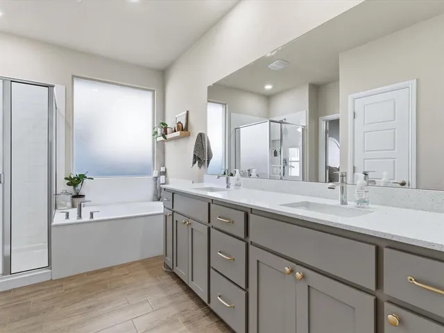 a bathroom with a tub sink and mirror