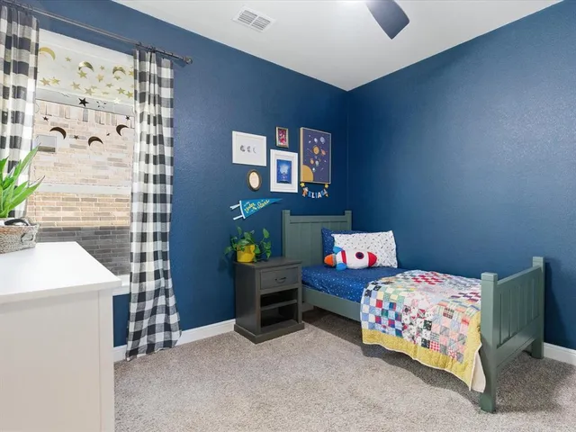 a bedroom with bed and a window