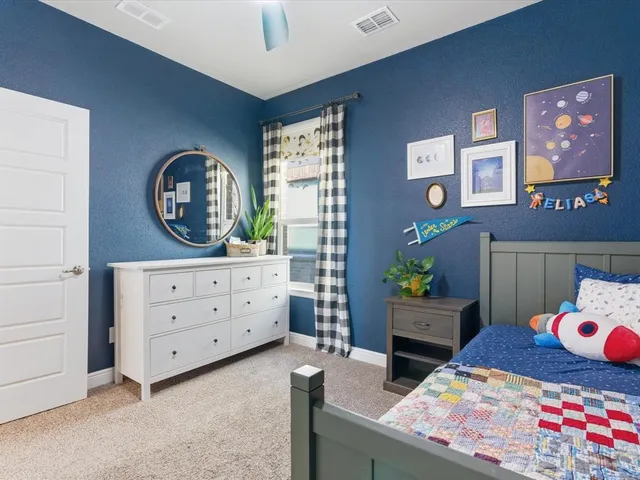 a bedroom with a bed and a dresser