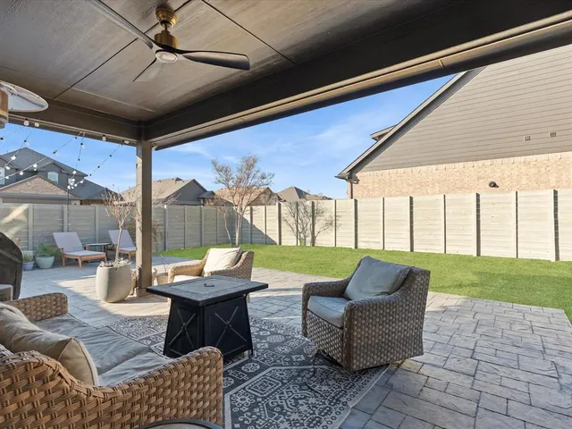 a outdoor living space with patio furniture and a garden