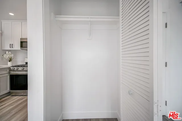 a kitchen with stainless steel appliances a refrigerator sink and microwave