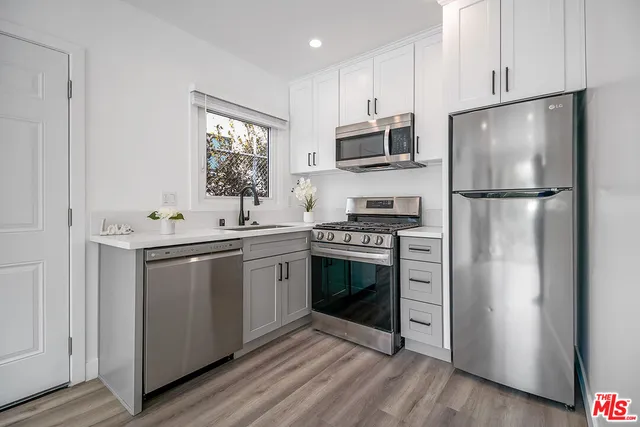 a kitchen with a microwave a stove and a refrigerator