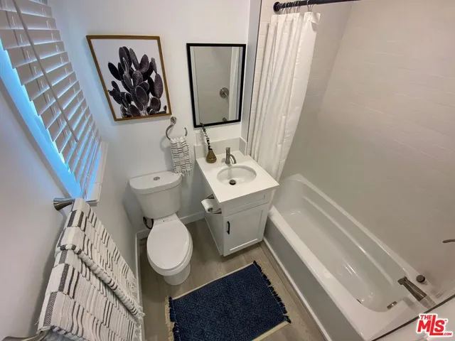 a bathroom with a sink toilet and mirror