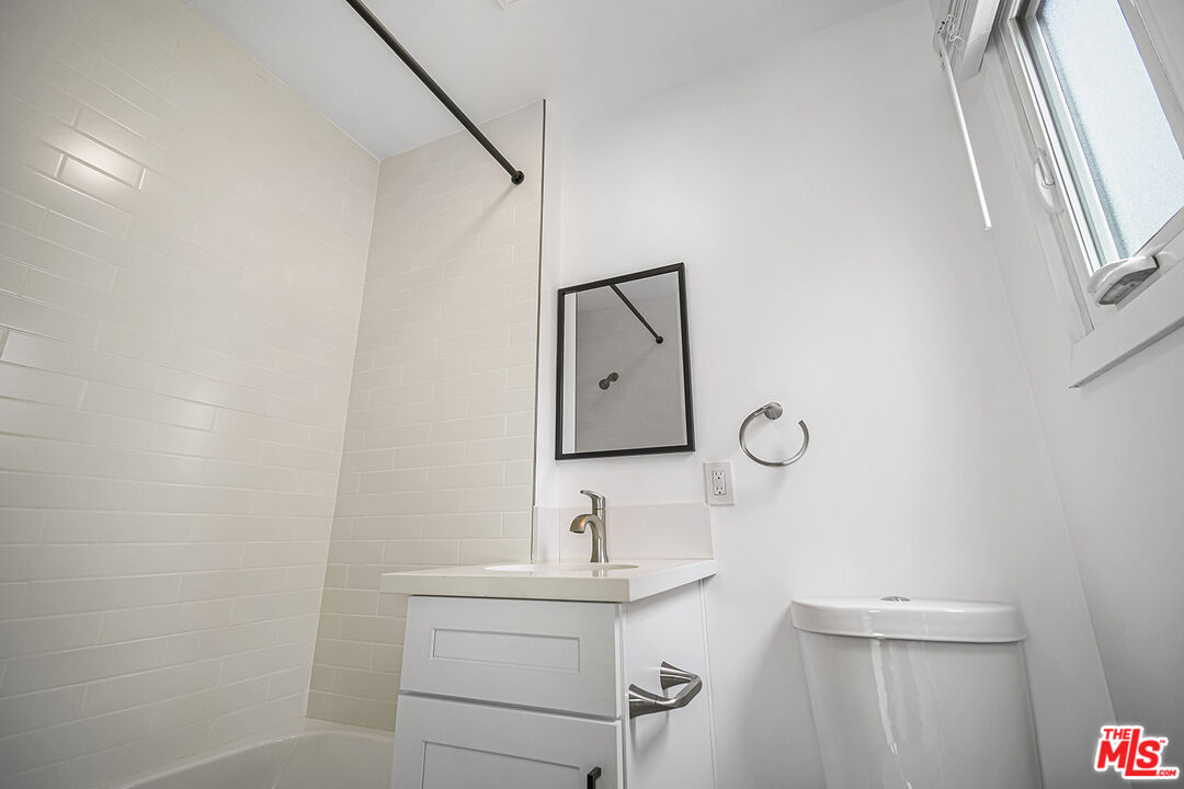 1217 9th Street, Unit 1 Santa Monica, CA 90401 - Photo 19 of 21 a bathroom with a sink toilet and mirror