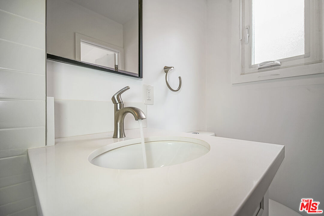 1217 9th Street, Unit 1 Santa Monica, CA 90401 - Photo 20 of 21 a bathroom with a sink and a window