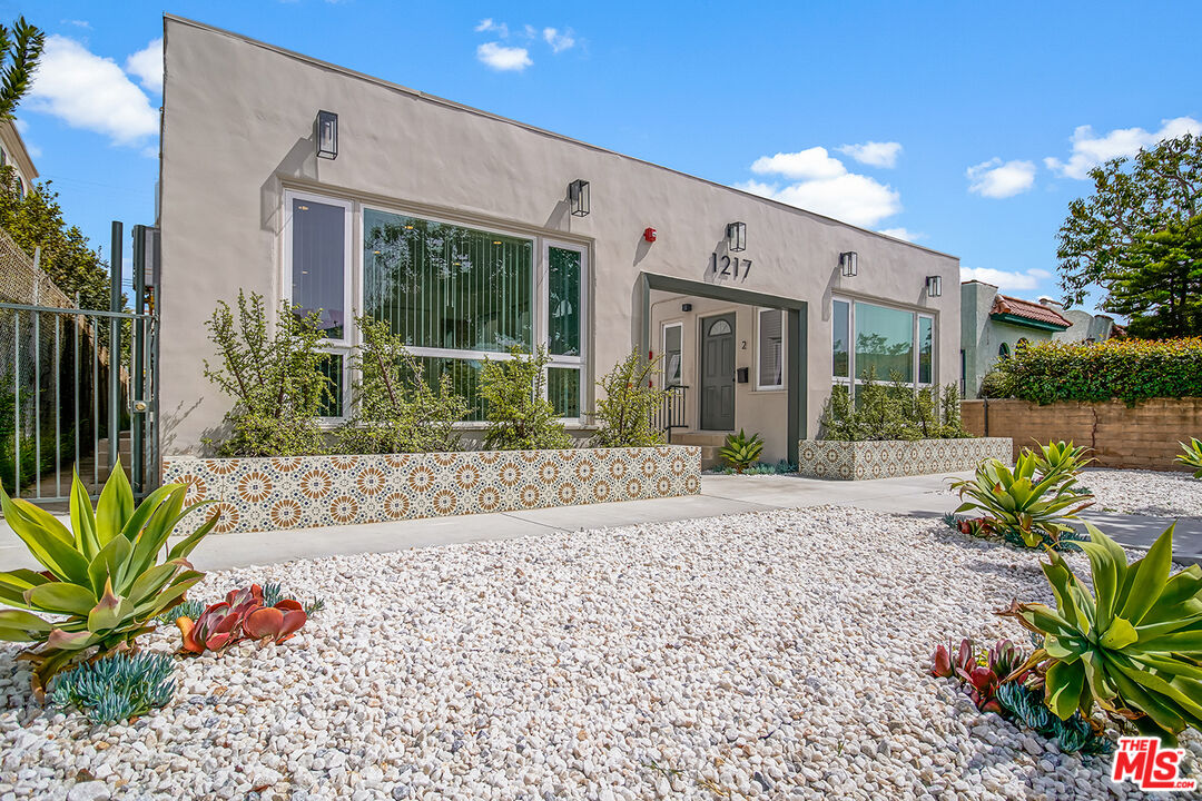 1217 9th Street, Unit 1 Santa Monica, CA 90401 - Photo 2 of 21 a front view of a house with a garden